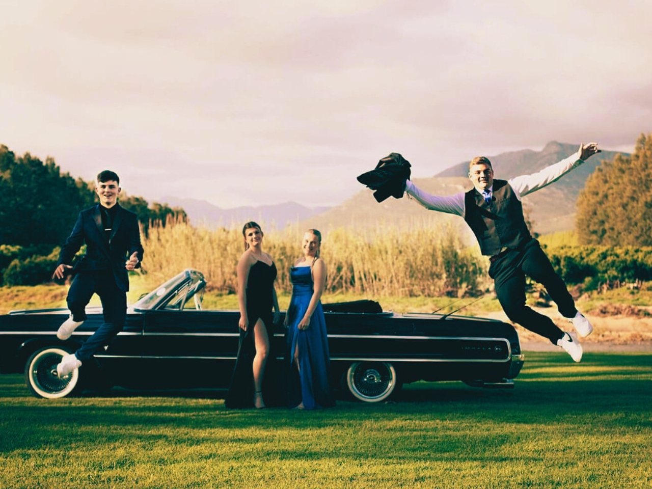 Students exited around a vintage vehicle for matric farewell rides 