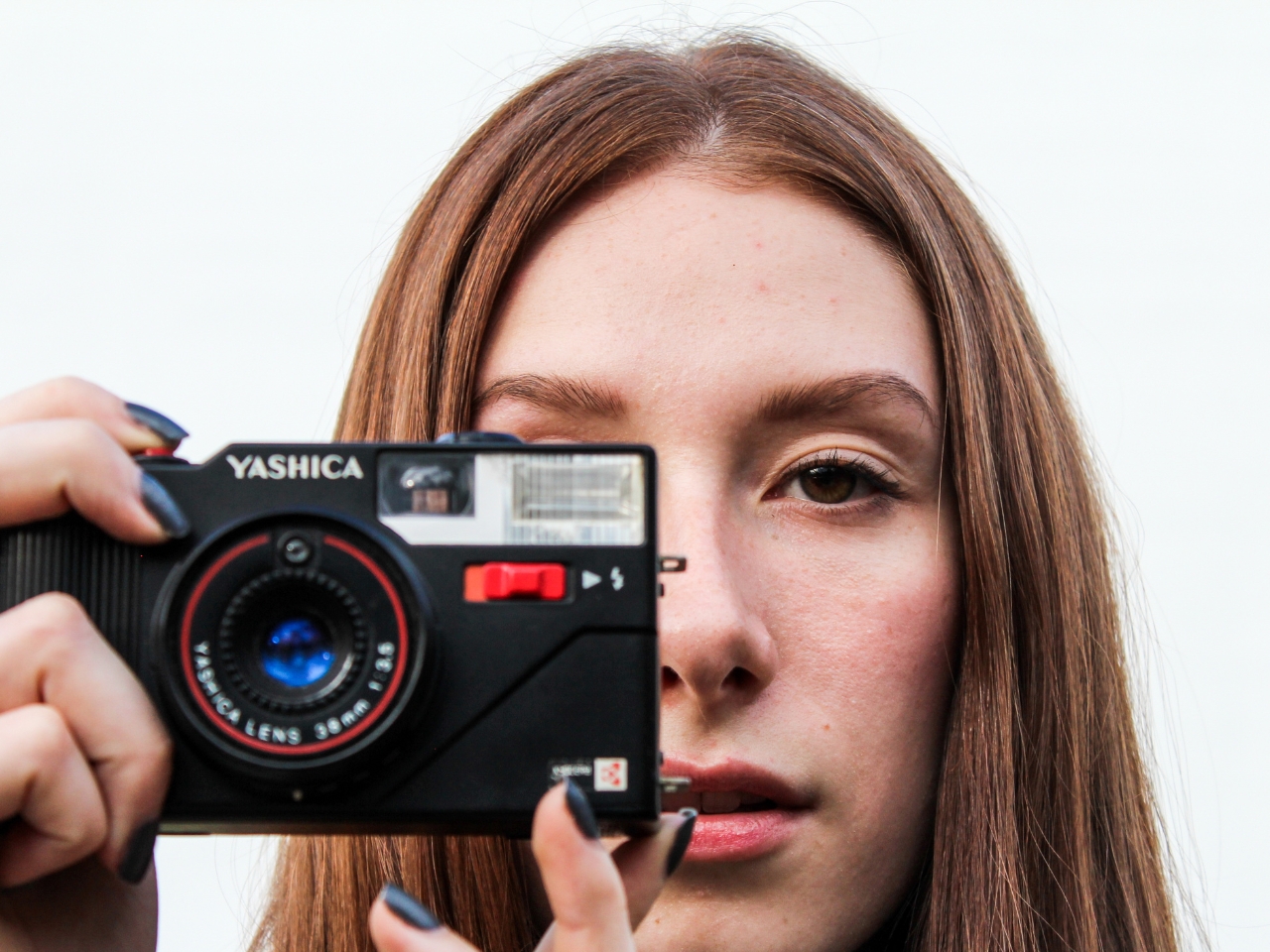 Female photographer taking a picture looking at me 