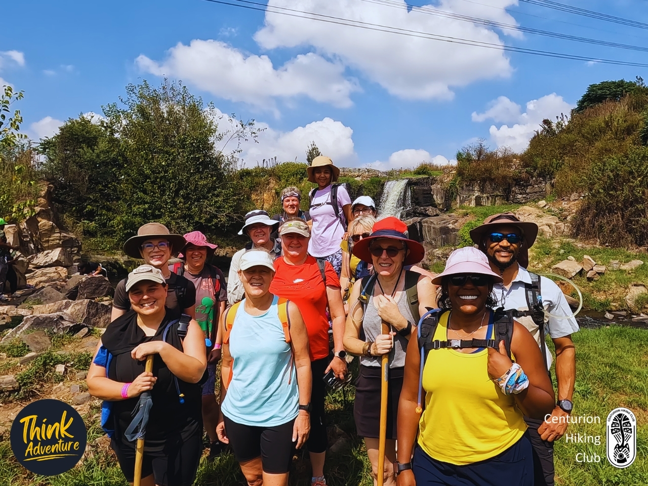 A group photo of hikers in front of the waterfall on the 11km trail at the Taroko Trail Park