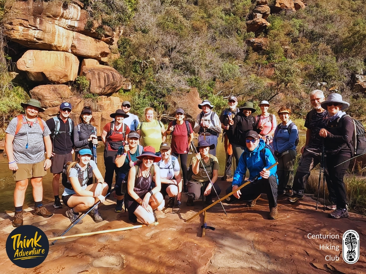 A group photo of hikers along the river at the Muningi Gorge Hike at Adventure Zone, Cullinan