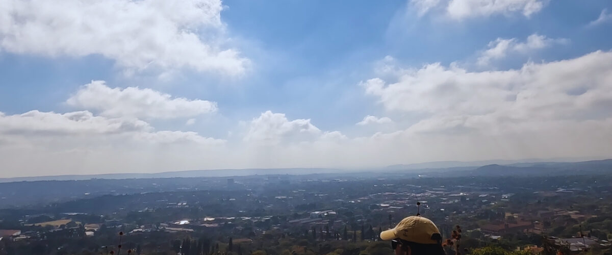 A hiker at a High Point of View on the Red Trail at the Klapperkop Nature Reserve