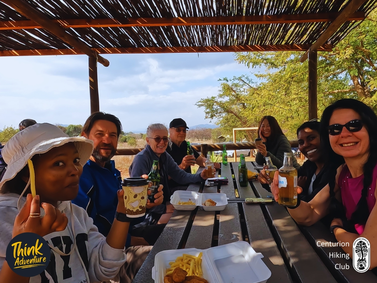 A group of hikers enjoying food and drinks at the Vergenoeg Cafe
