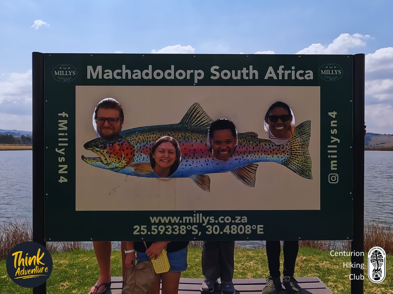 Hikers posing behind the rainbow trout photo board at Millys on the N4 in Machadodorp, Mpumalanga